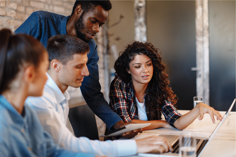 People looking at computer in meeting